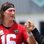 Jacksonville Jaguars quarterback Trevor Lawrence (16) fist bumps executive vice president of football operations Tony Boselli during the first organized team activity at Miller Electric Center Monday, May 19, 2025 in Jacksonville, Fla.