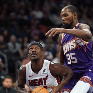 Miami Heat forward Jimmy Butler (22) drives against Phoenix Suns forward Kevin Durant (35) during the second half at Footprint Center.