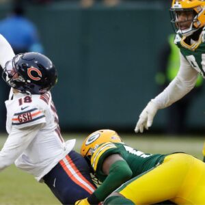 Green Bay Packers linebacker Edgerrin Cooper (56) wraps up Chicago Bears quarterback Caleb Williams (18) on Sunday, January 5, 2024 at Lambeau Field in Green Bay, Wis. The Bears defeated the Packers 24-22.