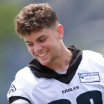 Philadelphia Eagles defensive back Cooper DeJean (33) plays with the children of running back Saquon Barkley during training camp at NovaCare Complex.