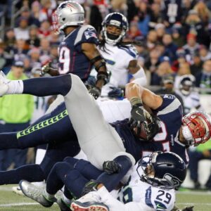 New England Patriots tight end Rob Gronkowski (87) dives forward against Seattle Seahawks free safety Earl Thomas (29) and strong safety Kam Chancellor (31) and in the second quarter at Gillette Stadium.
