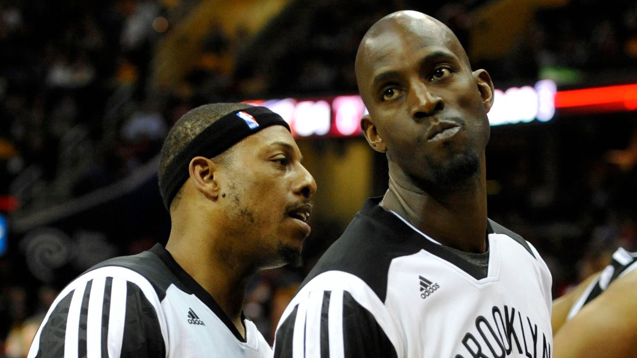 Brooklyn Nets forward Paul Pierce (left) talks to center Kevin Garnett (2) at halftime of a game against the Cleveland Cavaliers at Quicken Loans Arena