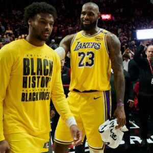 Feb 20, 2025; Portland, Oregon, USA; Los Angeles Lakers forward LeBron James (23) celebrates victory over the Portland Trail Blazers with his son guard Bronny James (9) at Moda Center.