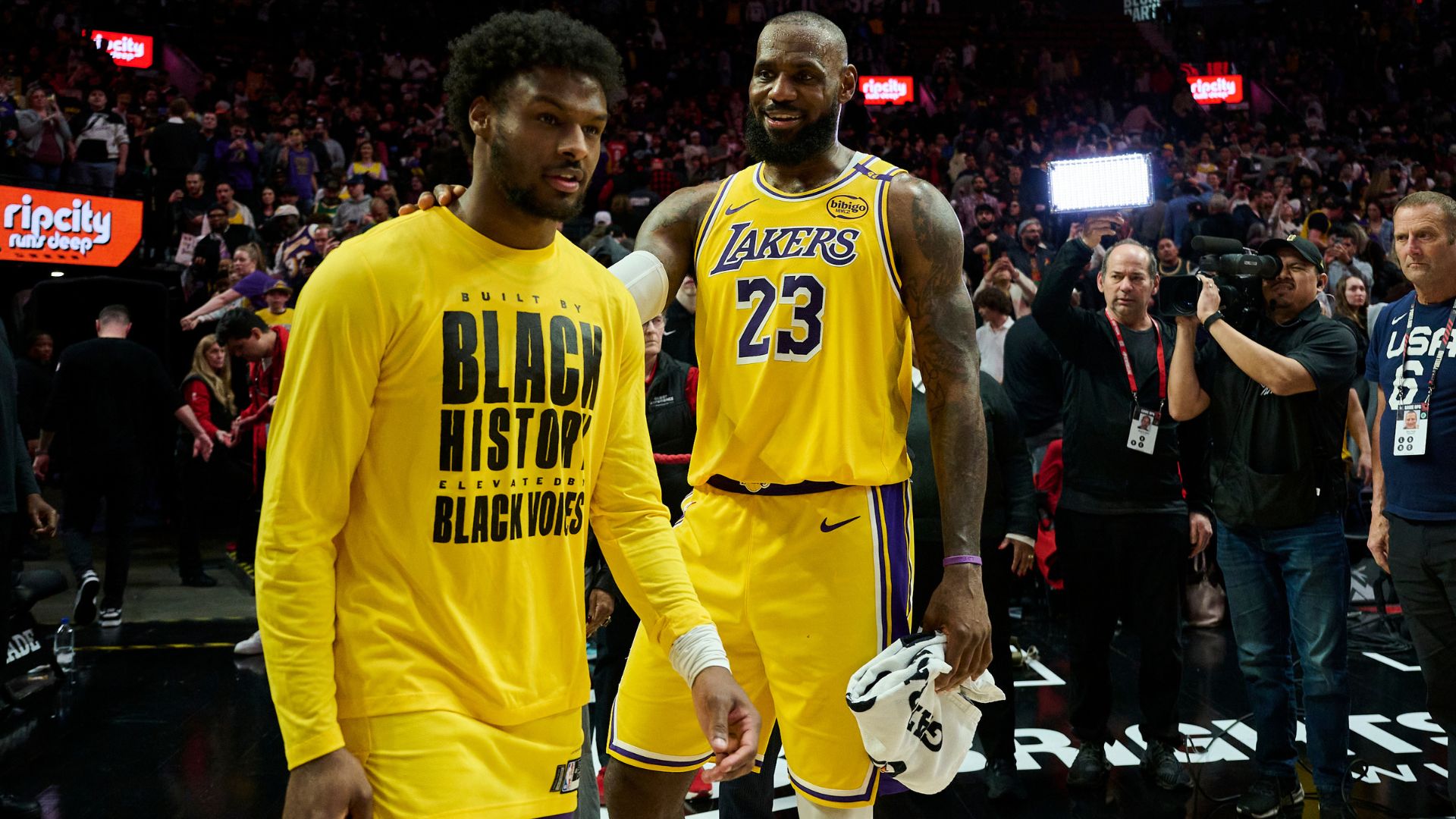 Feb 20, 2025; Portland, Oregon, USA; Los Angeles Lakers forward LeBron James (23) celebrates victory over the Portland Trail Blazers with his son guard Bronny James (9) at Moda Center.