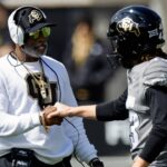 Apr 19, 2025; Boulder, CO, USA; Colorado Buffaloes head coach Deion Sanders and place kicker Buck Buchanan (43) during the spring game at Folsom Field.