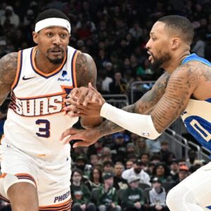 Phoenix Suns guard Bradley Beal (3) drives against Milwaukee Bucks guard Damian Lillard (0) on the second half at Fiserv Forum.