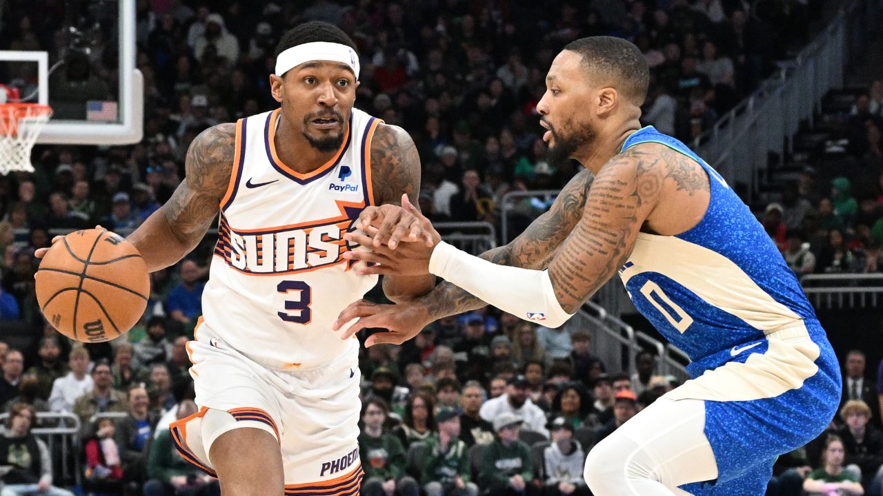 Phoenix Suns guard Bradley Beal (3) drives against Milwaukee Bucks guard Damian Lillard (0) on the second half at Fiserv Forum.