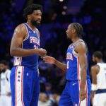 Philadelphia 76ers center Joel Embiid (21) reacts with guard Tyrese Maxey (0) against the Dallas Mavericks in the second quarter at Wells Fargo Center.