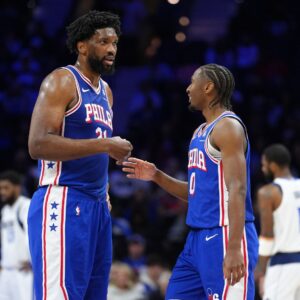 Philadelphia 76ers center Joel Embiid (21) reacts with guard Tyrese Maxey (0) against the Dallas Mavericks in the second quarter at Wells Fargo Center.