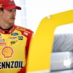 NASCAR Cup Series driver Joey Logano (22) stands in his garage Friday, July 25, 2025, ahead of practice at Indianapolis Motor Speedway in preparation for the Brickyard 400.