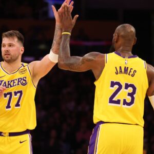 Los Angeles Lakers forward LeBron James (23) and guard Luka Doncic (77) react after a play during the first quarter against the Minnesota Timberwolves at Crypto.com Arena.