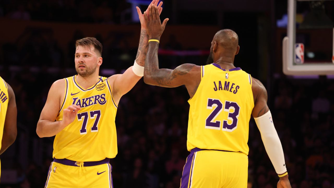 Los Angeles Lakers forward LeBron James (23) and guard Luka Doncic (77) react after a play during the first quarter against the Minnesota Timberwolves at Crypto.com Arena.