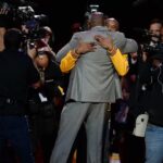 Los Angeles Lakers forward Kobe Bryant (facing camera) hugs former Laker player Magic Johnson before a game against the Utah Jazz at Staples Center.