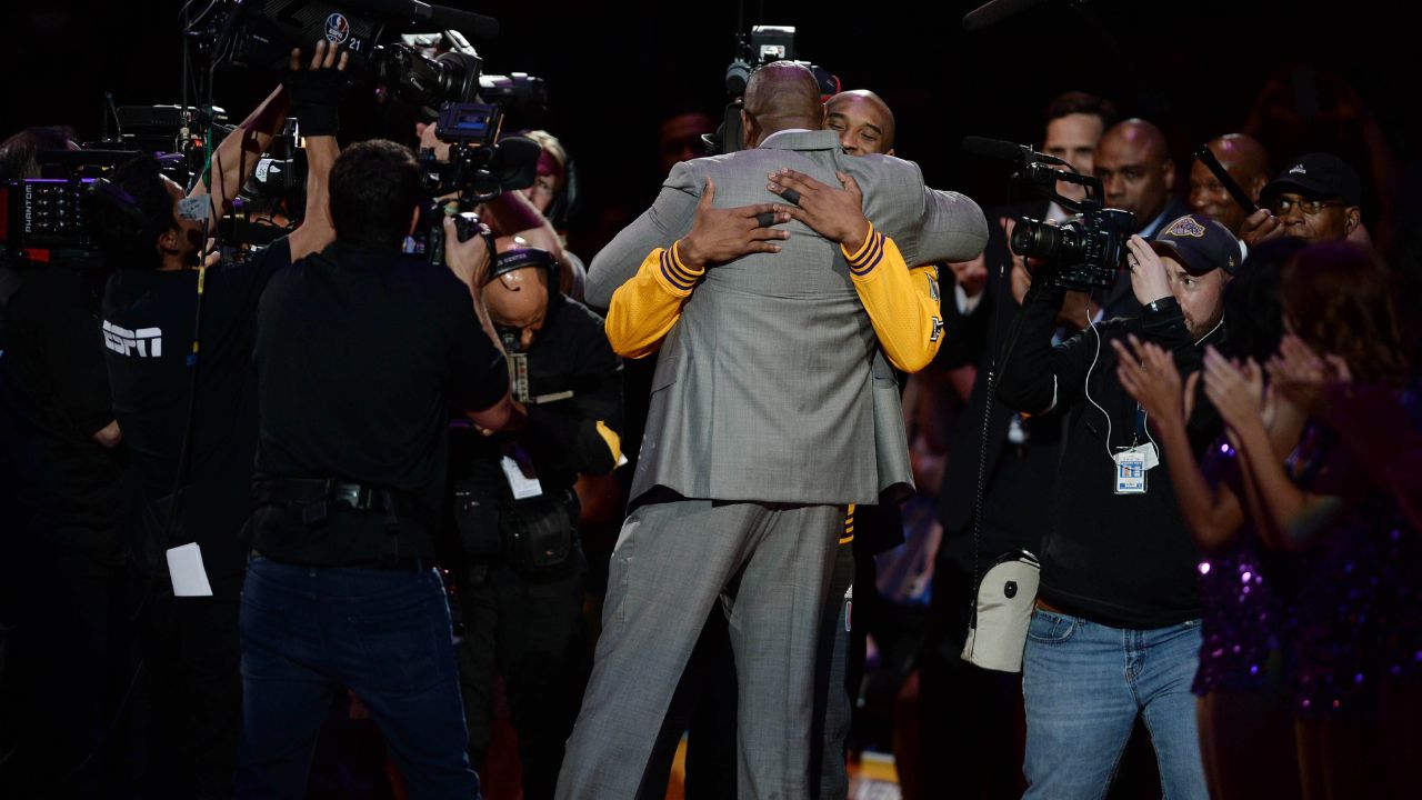 Los Angeles Lakers forward Kobe Bryant (facing camera) hugs former Laker player Magic Johnson before a game against the Utah Jazz at Staples Center.
