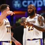 Los Angeles Lakers guard Luka Doncic (77) and Los Angeles Lakers forward LeBron James (23) on the sidelines against the Chicago Bulls during the first half at Crypto.com Arena.