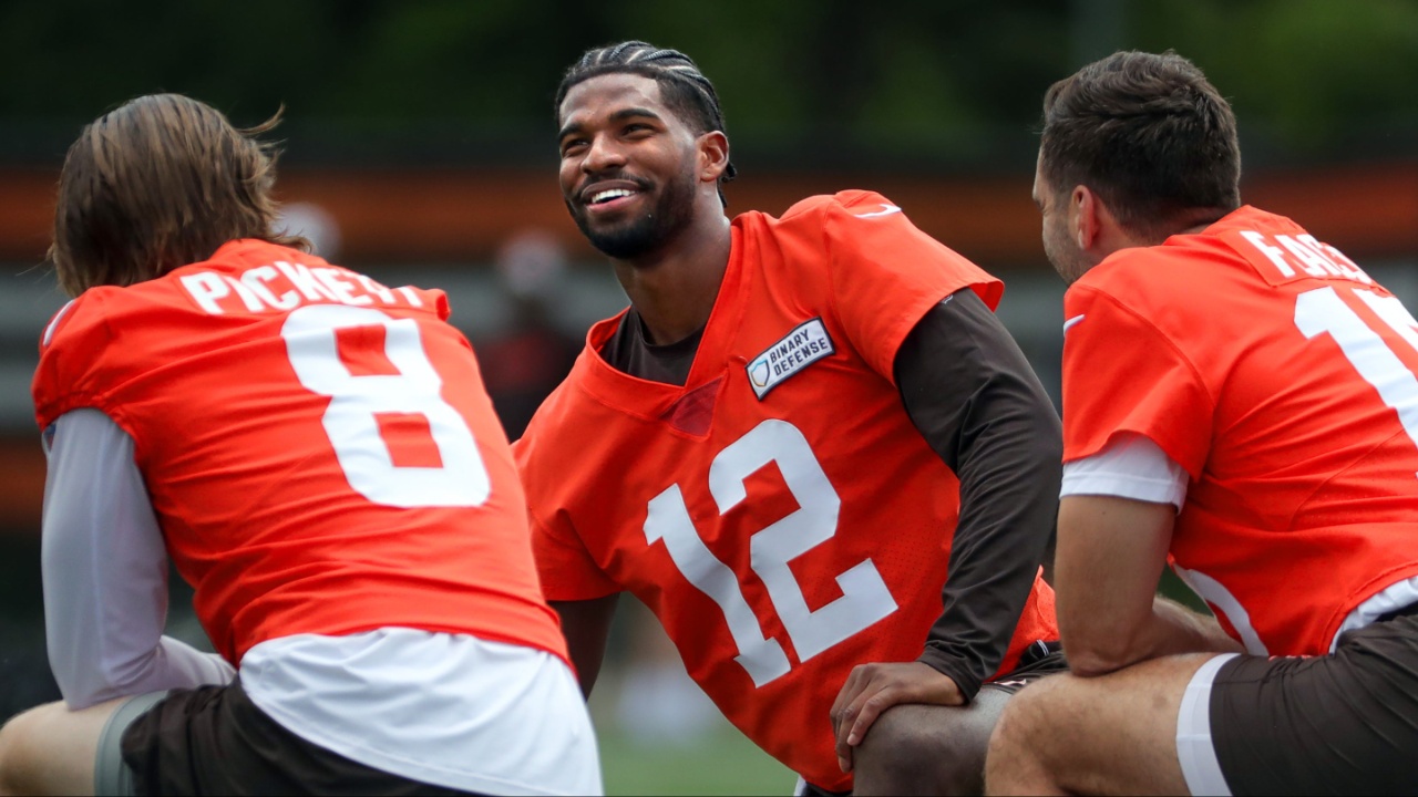 Browns quarterbacks Shedeur Sanders (12), Kenny Pickett (8) and Joe Flacco (15) talk during minicamp June 10, 2025, in Berea, Ohio.