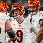 Cincinnati Bengals quarterback Joe Burrow (9) is pulled back to his feet after being sacked in the second quarter of the NFL Week 18 game between the Pittsburgh Steelers and the Cincinnati Bengals at Acrisure Stadium in Pittsburgh on Saturday, Jan. 4, 2025.