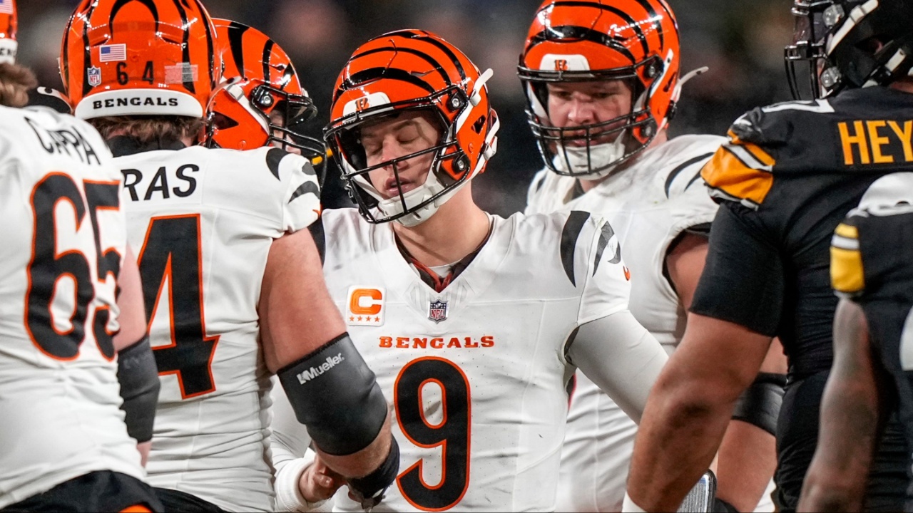 Cincinnati Bengals quarterback Joe Burrow (9) is pulled back to his feet after being sacked in the second quarter of the NFL Week 18 game between the Pittsburgh Steelers and the Cincinnati Bengals at Acrisure Stadium in Pittsburgh on Saturday, Jan. 4, 2025.