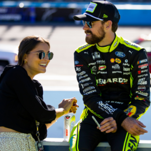 Nov 6, 2022; Avondale, Arizona, USA; NASCAR Cup Series driver Ryan Blaney (right) with girlfriend Gianna Tulio during the Cup Championship race at Phoenix Raceway. Mandatory Credit: Mark J. Rebilas-Imagn Images