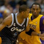 Tracy McGrady of the Orlando Magic is guarded by Los Angeles Lakers guard Kobe Bryant (8) during 113-110 overtime loss during an NBA basketball game, Monday, March 15, 2004, in Los Angeles.