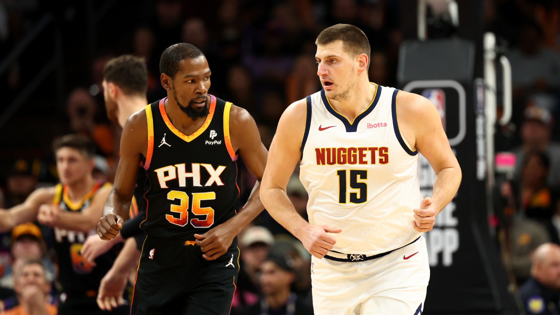 Dec 1, 2023; Phoenix, Arizona, USA; Denver Nuggets center Nikola Jokic (15) against Phoenix Suns forward Kevin Durant (35) at Footprint Center.