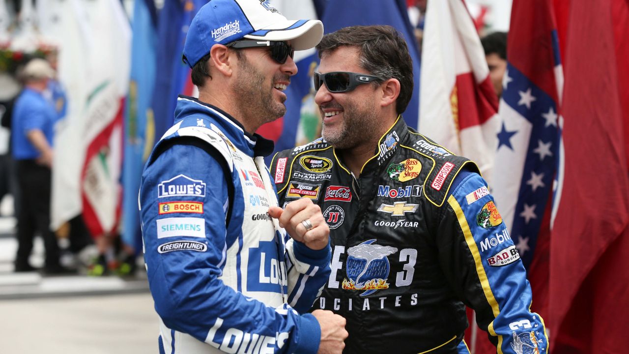 NASCAR Sprint Cup Series drivers Jimmie Johnson (L) and driver Tony Stewart (14) (R) share a laugh prior to the GoBowling.com 400 at Pocono Raceway.