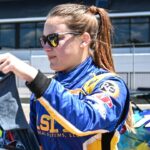 Kaylee Bryson signs an autograph during the grid walk before the Trans Am Speed Tour main event Sunday, June 30, 2024, at Road America in Elkhart Lake, Wisconsin.
