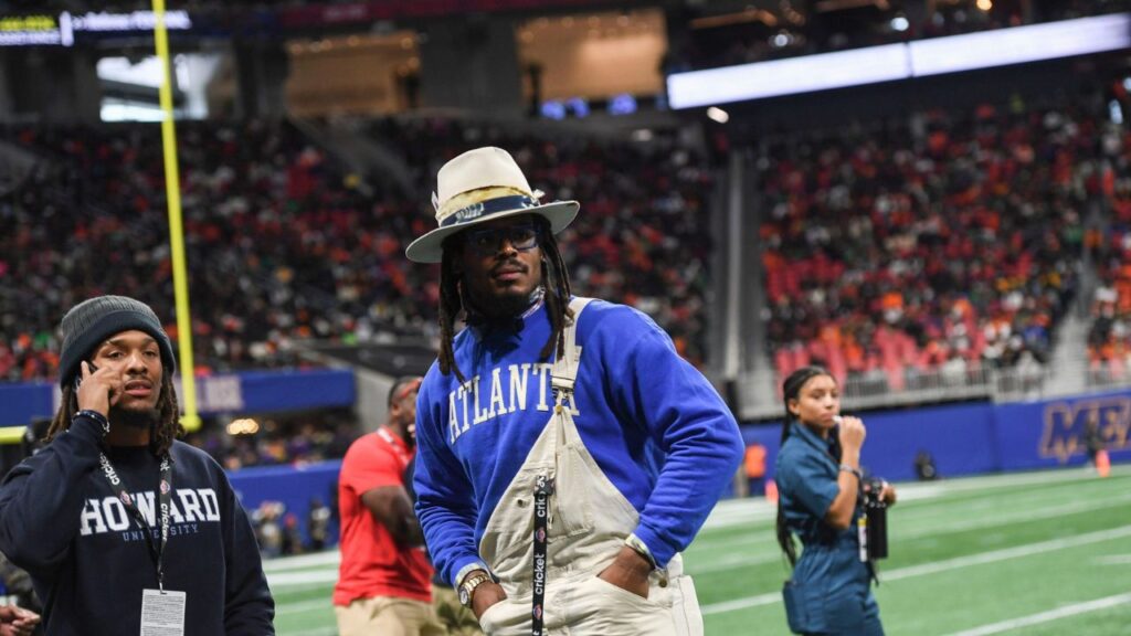 Former Auburn and NFL star Cam Newton stands on the sidelines during the Cricket Celebration Bowl game between Florida A&M University and Howard University at Mercedes-Benz Stadium in Atlanta on Dec. 16, 2023