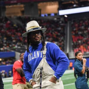 Former Auburn and NFL star Cam Newton stands on the sidelines during the Cricket Celebration Bowl game between Florida A&M University and Howard University at Mercedes-Benz Stadium in Atlanta on Dec. 16, 2023