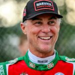 Former NASCAR Cup Series champion Kevin Harvick smiles during an autograph session before the 13th annual Masters of the Pros 200 race on Wednesday, July 16, 2025, at the Owosso Speedway. Harvick and his 13-year-old son Keelan competed against each other in the race later in the night.
