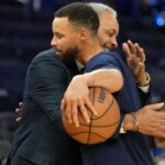 Charlotte Hornets color commentator Dell Curry (left) and Golden State Warriors guard Stephen Curry (right) hug before the game at Chase Center.
