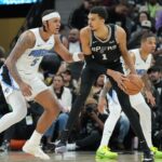 San Antonio Spurs center Victor Wembanyama (1) looks to pass in front of Orlando Magic forward Paolo Banchero (5) in the second half at Frost Bank Center.