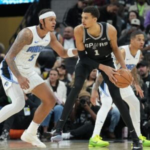 San Antonio Spurs center Victor Wembanyama (1) looks to pass in front of Orlando Magic forward Paolo Banchero (5) in the second half at Frost Bank Center.