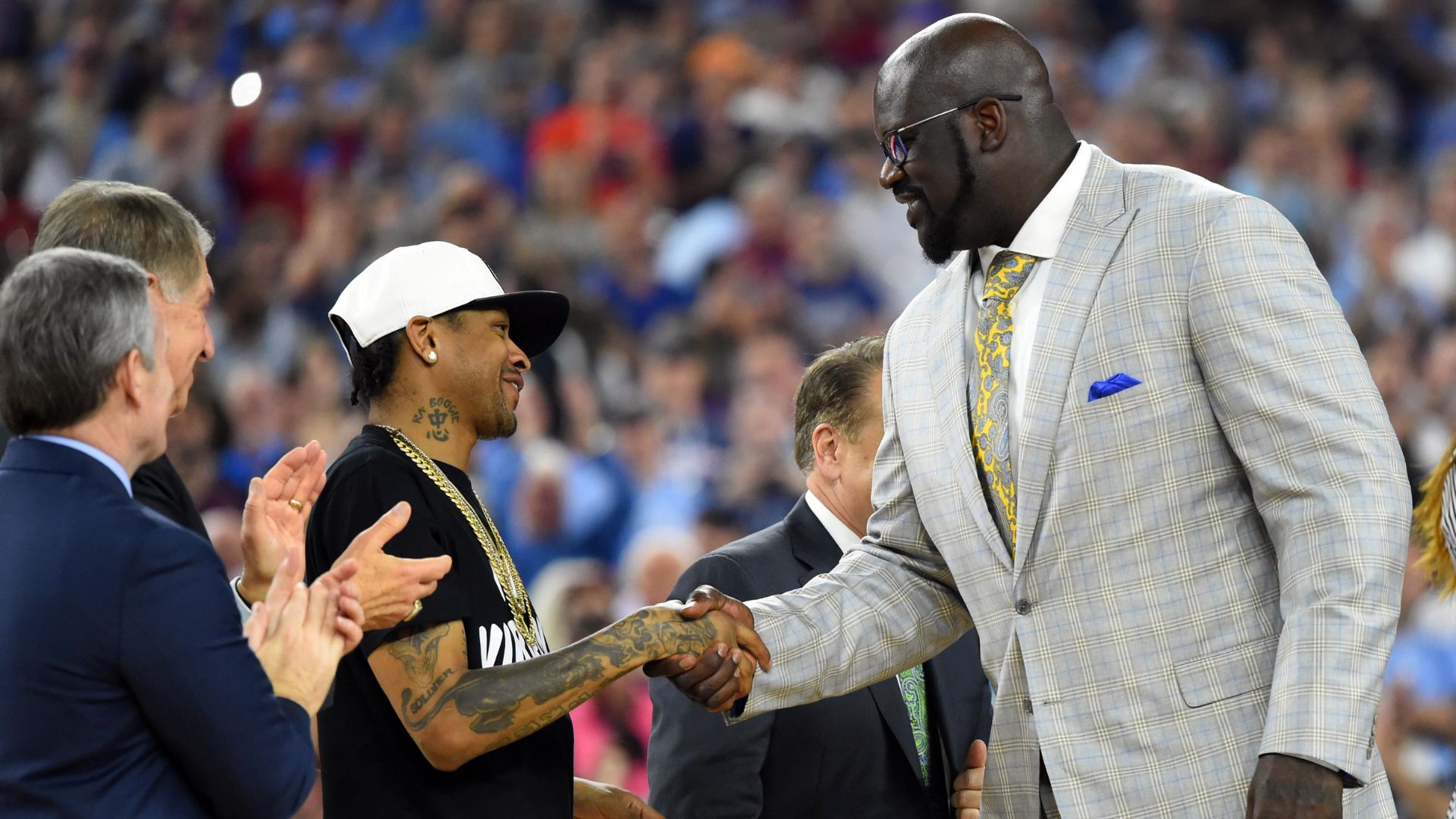 Apr 4, 2016; Houston, TX, USA; Shaquille O'Neal shakes hands with Allen Iverson as they are introduced at halftime of the championship game of the 2016 NCAA Men's Final Four after being inducted into the basketball hall of fame at NRG Stadium.