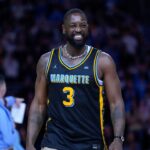 Former Marquette Golden Eagles player Dwyane Wade smiles timeout during the first half of the game against the Providence Friars at Fiserv Forum