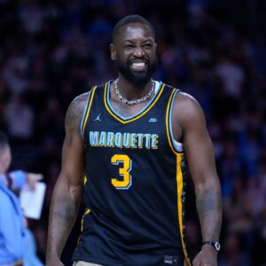 Former Marquette Golden Eagles player Dwyane Wade smiles timeout during the first half of the game against the Providence Friars at Fiserv Forum