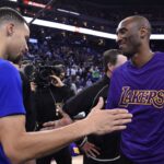 Golden State Warriors guard Stephen Curry (30, left) shakes hands with Los Angeles Lakers forward Kobe Bryant (24, right) before the game at Oracle Arena.