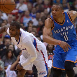 Los Angeles Clippers guard Chris Paul (3) and Oklahoma City Thunder guard Russell Westbrook (0) race toward the ball in game four of the second round of the 2014 NBA Playoffs at Staples Center.