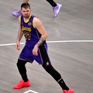Apr 9, 2025; Dallas, Texas, USA; Los Angeles Lakers guard Luka Doncic (77) celebrates after making a basket Dallas Mavericks during the fourth quarter at the American Airlines Center.