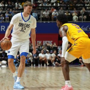 Dallas Mavericks forward Cooper Flagg (32) dribbles against Los Angeles Lakers guard Bronny James (9) in the first quarter of their game at Thomas & Mack Center.