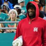 Los Angeles Clippers guard John Wall watches the game between the Miami Dolphins and the Dallas Cowboys during the first half at Hard Rock Stadium.