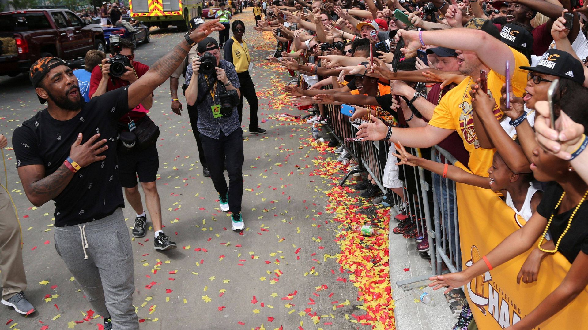 Cleveland Cavaliers Kyrie Irving celebrates with the crowd in downtown Cleveland Cleveland Cavaliers Kyrie Irving celebrates with the crowd during a parade to celebrate winning the 2016 NBA Championship in downtown Cleveland, Ohio.