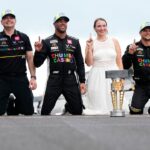 NASCAR Cup Series driver Bubba Wallace (23) celebrates on the yard of bricks Sunday, July 27, 2025, during the Brickyard 400 at Indianapolis Motor Speedway.