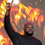 Shaquille O'Neal holds up the sign of the horns during a DJ performance ahead of the College Football Playoff semifinal game between the Texas Longhorns and Ohio State in the Cotton Bowl at AT&T Stadium on Friday, Jan. 10, 2024 in Arlington, Texas.