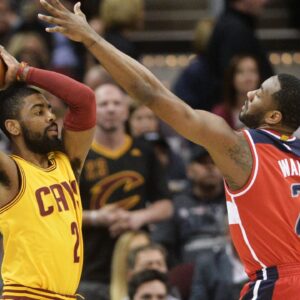 Washington Wizards guard John Wall (2) defends Cleveland Cavaliers guard Kyrie Irving (2) during the first quarter at Quicken Loans Arena.