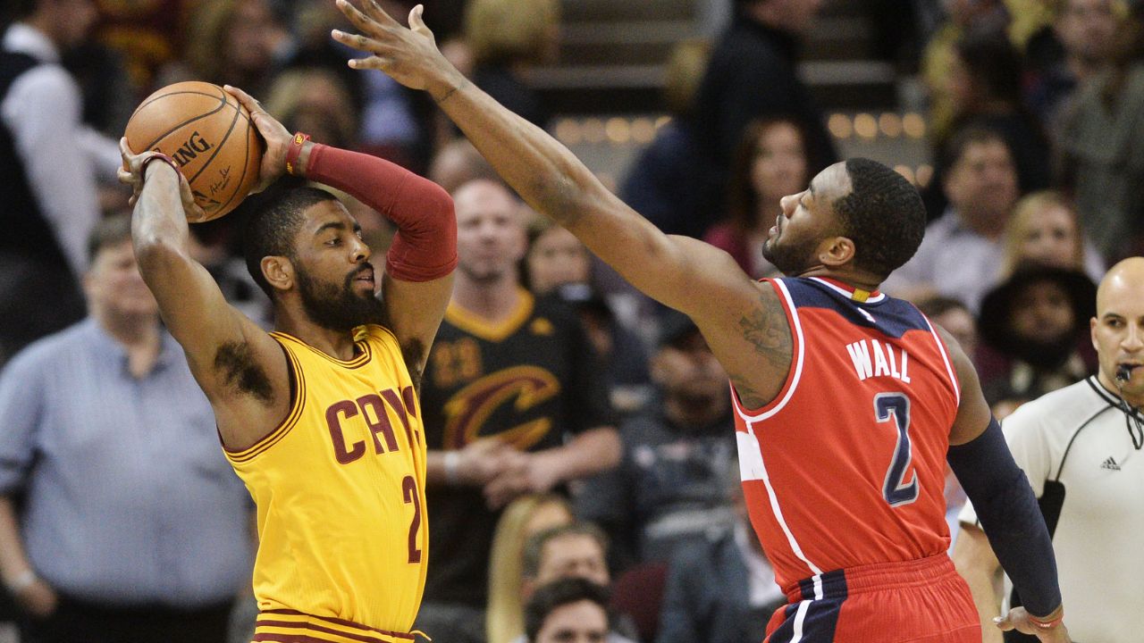 Washington Wizards guard John Wall (2) defends Cleveland Cavaliers guard Kyrie Irving (2) during the first quarter at Quicken Loans Arena.