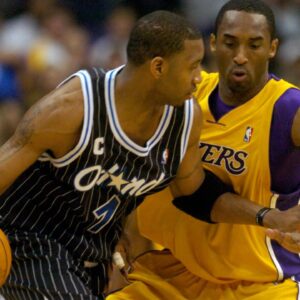 Tracy McGrady of the Orlando Magic is guarded by Los Angeles Lakers guard Kobe Bryant (8) during 113-110 overtime loss during an NBA basketball game, Monday, March 15, 2004, in Los Angeles.