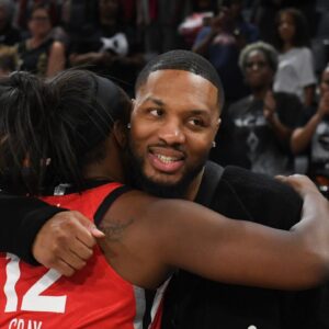 Las Vegas Aces guard Chelsea Gray (12) hugs NBA player Damian Lillard after her game against the Los Angeles Sparks at Michelob Ultra Arena.