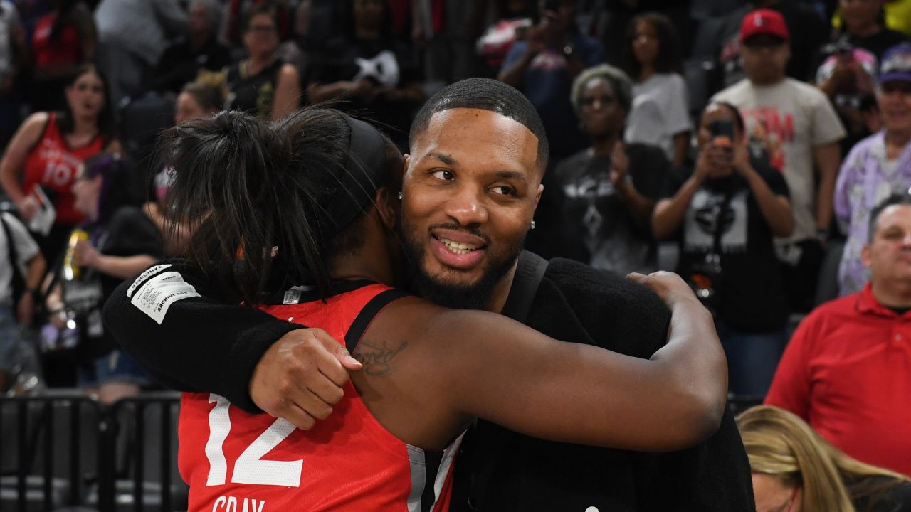 Las Vegas Aces guard Chelsea Gray (12) hugs NBA player Damian Lillard after her game against the Los Angeles Sparks at Michelob Ultra Arena.