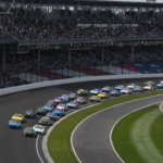 INDIANAPOLIS, IN - JULY 21: The field races into turn one on the stage two restart during the NASCAR, Motorsport, USA Cup Series Brickyard 400 on July 21, 2024, at the Indianapolis Motor Speedway in Indianapolis, Indiana. (Photo by Michael Allio Icon Sportswire) AUTO: JUL 21 NASCAR Cup Series Brickyard 400 EDITORIAL USE ONLY Icon116240721018